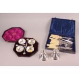 A pair of squat silver candlesticks, a cased set of four Mappin & Webb silver plated salts and a