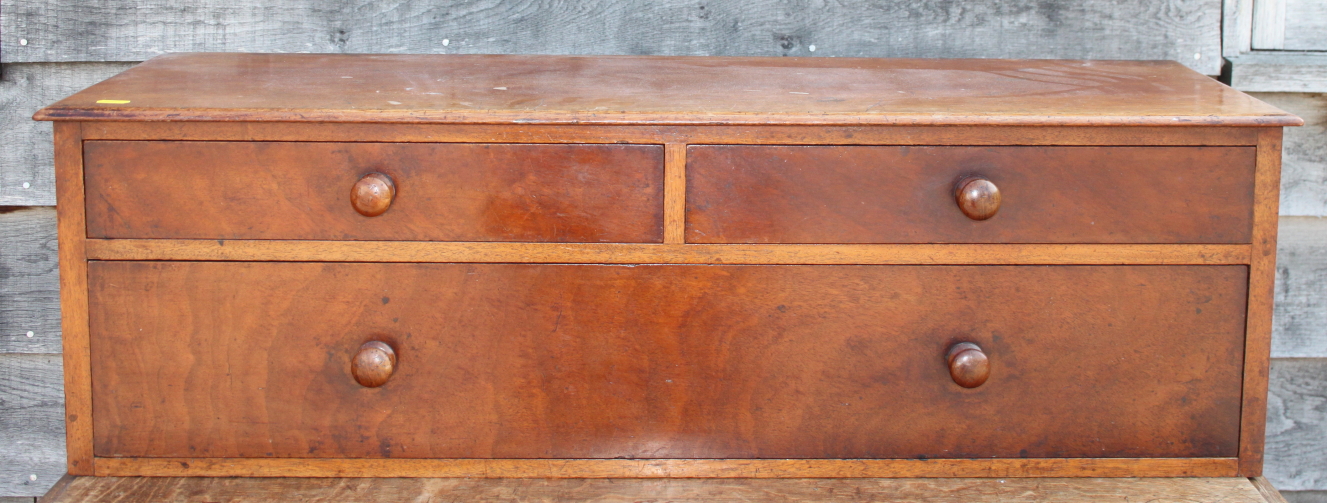 A 19th century mahogany chest of two short and one long drawer with turned wooden knobs, 37" wide