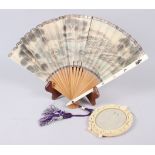 A Shibayama fan and a carved ivory oval picture frame