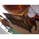 An oak sideboard, fitted two drawers with guilloche decoration and lower cupboard, 48" wide