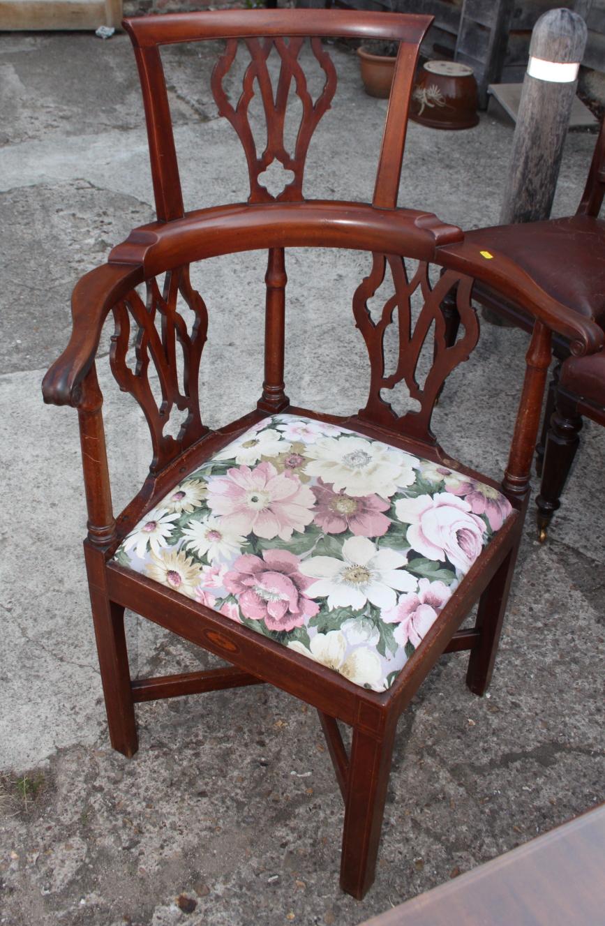 A George III mahogany corner chair with pierced vase shaped splats and seat rails inlaid shells