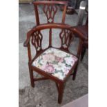 A George III mahogany corner chair with pierced vase shaped splats and seat rails inlaid shells