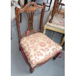 A late 19th century low seat nursing chair with fretted splat, on turned front supports, an