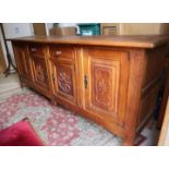 A Belgian carved oak sideboard, fitted two end cupboards, centre drawers and further cupboards,