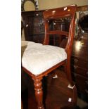 A set of four 19th century mahogany dining chairs with plain top and back rails and stuffed over