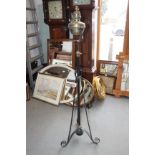 An Edwardian brass oil lamp, on black metal stand with tripod base