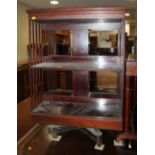 An early 20th century mahogany revolving bookcase with slatted sides, 26" wide