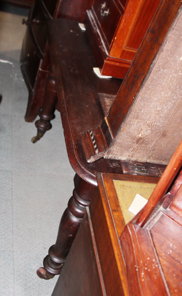 A 19th century mahogany extending dining table with centre leaf and winding handle, on turned