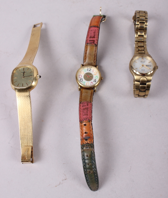 A lady's Longines wristwatch, on flexible yellow metal bracelet, and two other wristwatches