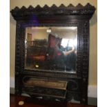 A late 19th century wall mounted hallstand, in heavily carved frame, fitted mirror and glove box,