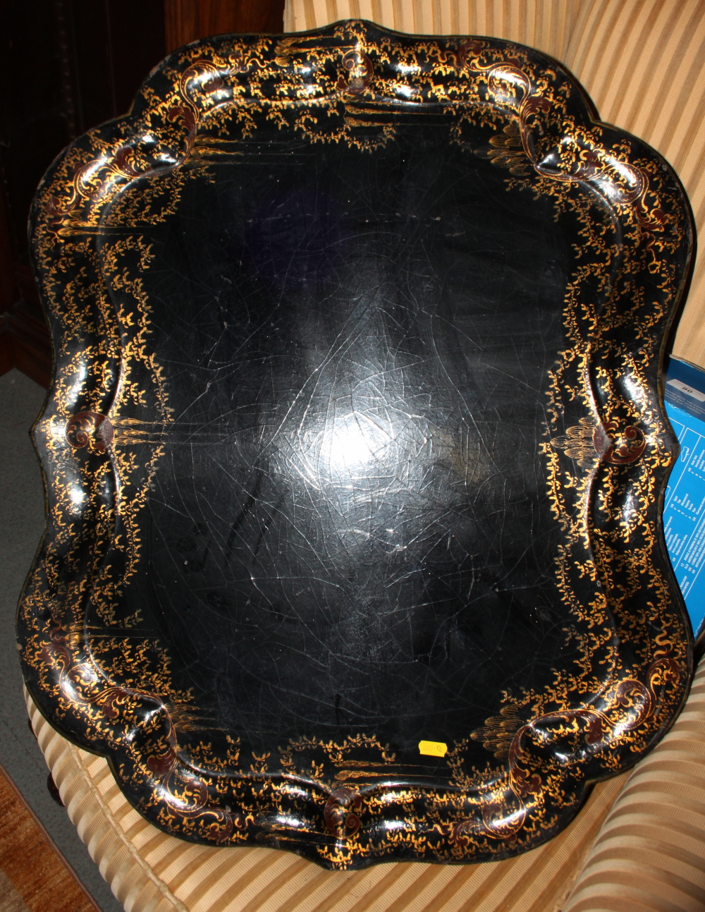 A 19th century papier-mache tray with gilt decorated border, 30" x 23"