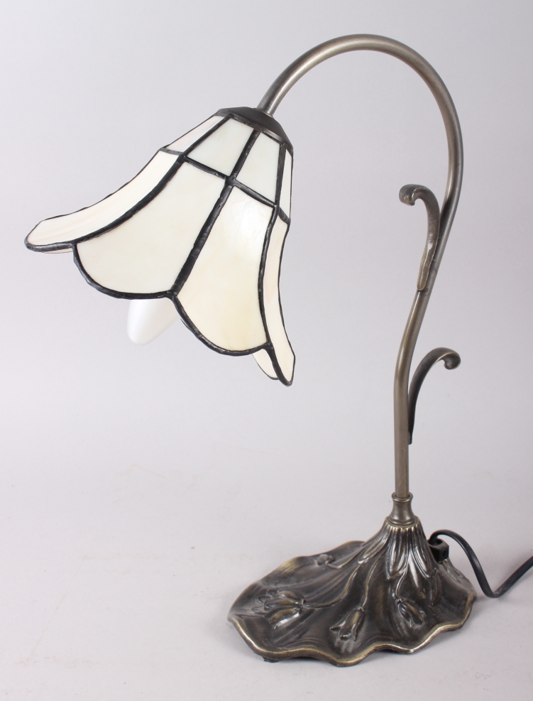 A Tiffany design table lamp with cream coloured glass panels, on metal base, decorated relief flower