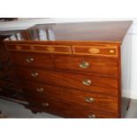 A George IV mahogany chest of two short and three long drawers with oval brass handles, and
