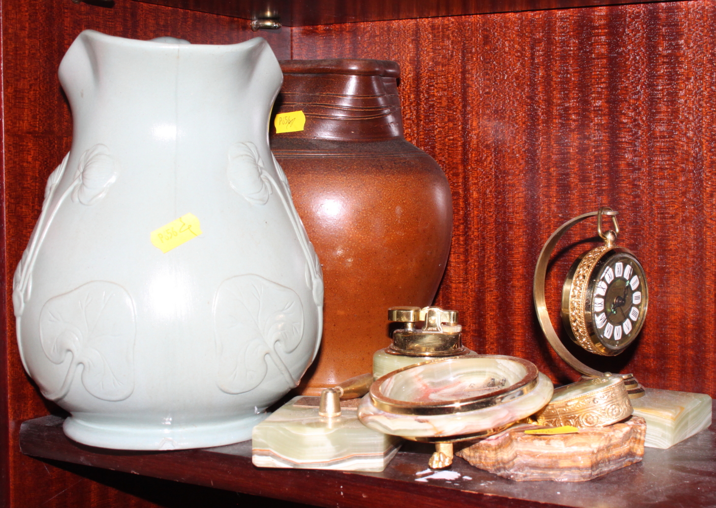 An Art Nouveau design jug, 9" high, an onyx table lighter, an onyx topped pill box and other items