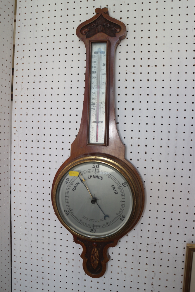 A carved walnut banjo barometer and thermometer