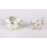 A two-handled silver porringer, engraved initials, and a silver sauce boat with cut edge, 7oz troy