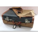 A cowhide suitcase with Cunard White Star Line label and canvas outer case, a bowler hat, a pair