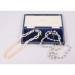 A two strand pearl necklace with sterling silver clasp set blue stone and another two-colour pearl