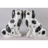 A pair of late 19th century Staffordshire models, seated spaniels, with black sponged decoration,