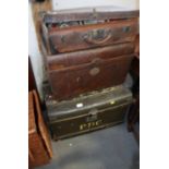 A collection of vintage tins, two tin trunks, a storage box and a leather suitcase
