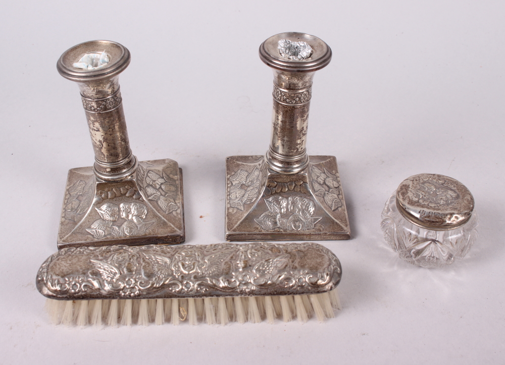 A pair of squat silver candlesticks embossed cherubs' heads, and a similar hand mirror, pin jar - Image 3 of 4