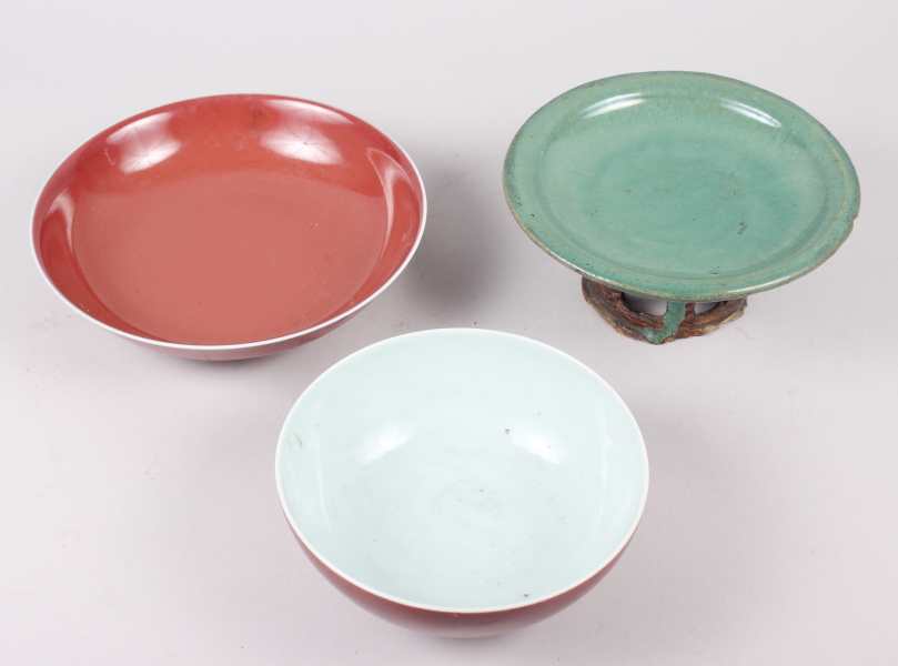 A Chinese sang de beouf bowl, 5 3/4" dia, a similar dish and a green glazed raised dish