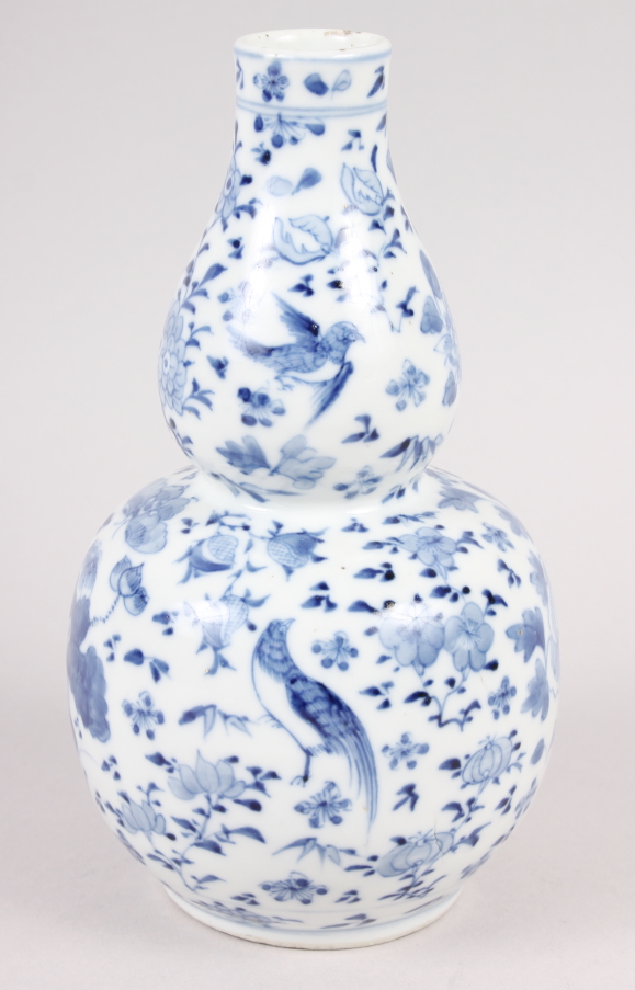 A 19th century Chinese blue and white double gourd vase, decorated birds amongst foliage, 7" high