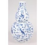 A 19th century Chinese blue and white double gourd vase, decorated birds amongst foliage, 7" high