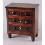 A 19th century miniature mahogany chest of two short and two long drawers, 8 1/2" wide