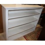 A white painted pine open bookcase, fitted three shelves, 54" wide