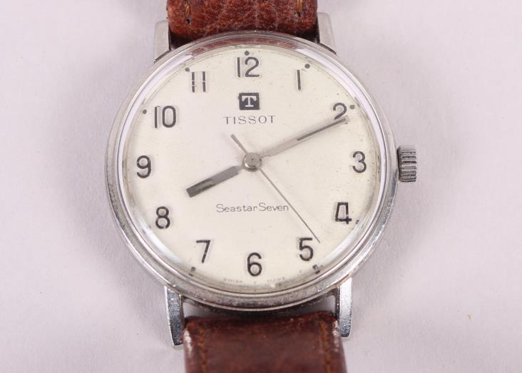 A stainless steel cased Tissot wristwatch with silvered dial and Arabic numerals, on leather strap