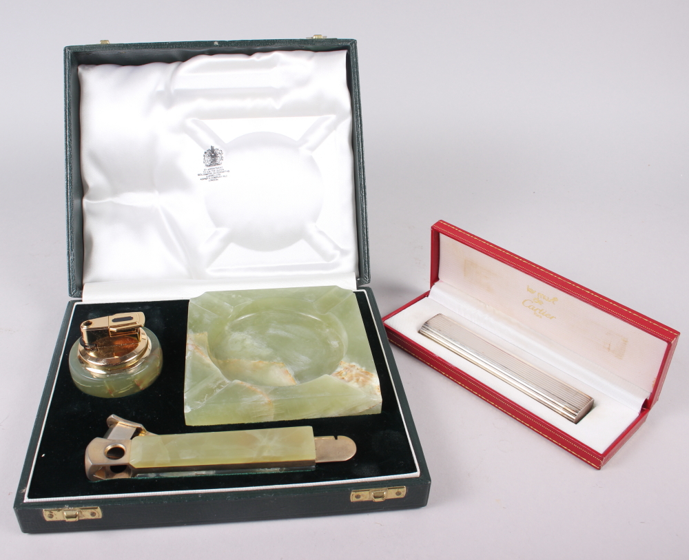 A Cartier silver plated gas table lighter, in box, and an Asprey's green onyx table lighter with