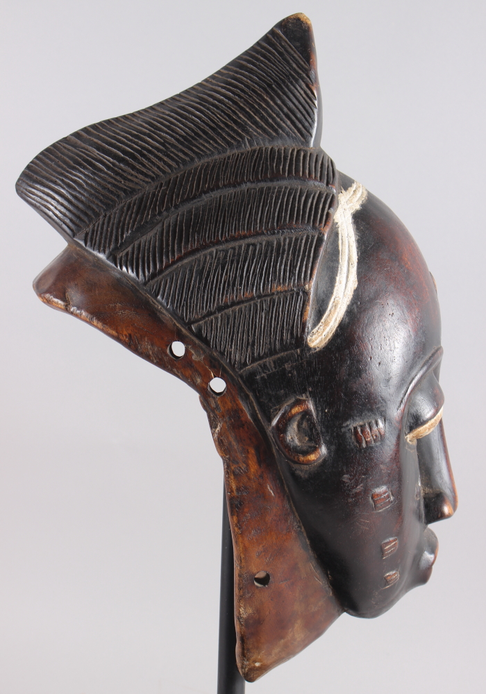 A West African carved hardwood tribal mask, on ebonised stand, 13 1/4" high - Image 5 of 6