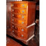 A Georgian design mahogany serpentine front bedside chest of seven drawers, on bracket feet, 16?