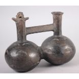 A pre-Columbian pottery wine ewer and a similar miniature oil jar