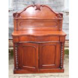 A mahogany serpentine front chiffonier with raised back, fitted shelf over one drawer and cupboards,