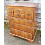 An 18th century walnut and line inlaid chest of four short and three long graduated drawers, on