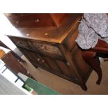 An oak sideboard, fitted two drawers with guilloche decoration and lower cupboard, 48" wide, an