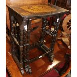 A set of three mid 19th century papier-mache black japanned occasional tables, on spindle turned