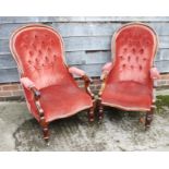 A pair of Victorian mahogany open armchairs, upholstered in a rust velour, on turned and castored