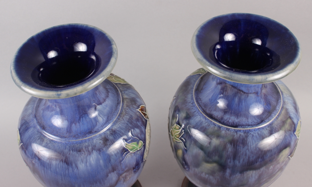 A pair of Royal Doulton blue glazed vases with flared tops and ovoid bodies, tub lined decoration of - Image 3 of 5