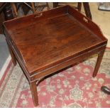 A mahogany tray top coffee table, on square taper supports, 28" wide x 24" deep x 21" high