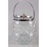 A cut glass and silver mounted biscuit jar and cover
