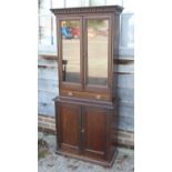An Edwardian walnut display cabinet, the glazed upper section fitted two drawers, over cupboards, on
