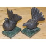 A pair of bronze model pigeons, on green marble bases, 9 1/2" high overall