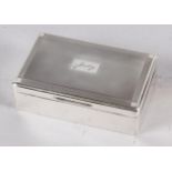 A rectangular engine turned silver table cigarette box, lid engraved "Judy"