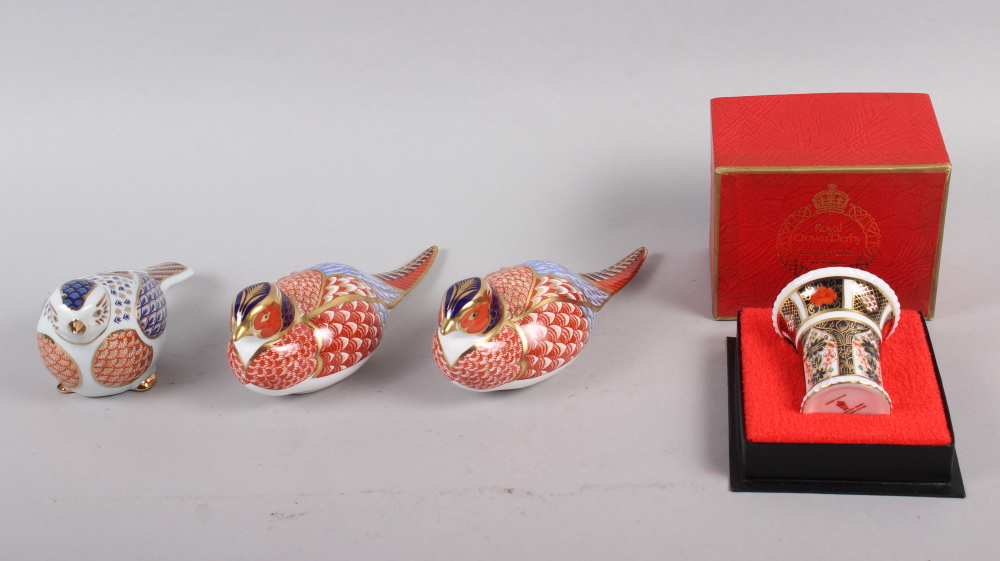 A pair of Royal Crown Derby paperweights, modelled as pheasants, gold stoppers, a similar