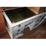 A white painted double pedestal desk with green tooled lined top, fitted seven drawers and central