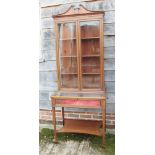 A Sheraton revival mahogany and banded inlaid display cabinet with swan neck pediment over glazed