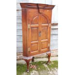 A Georgian mahogany corner cupboard enclosed arched top panel doors, on cabriole supports, 36"